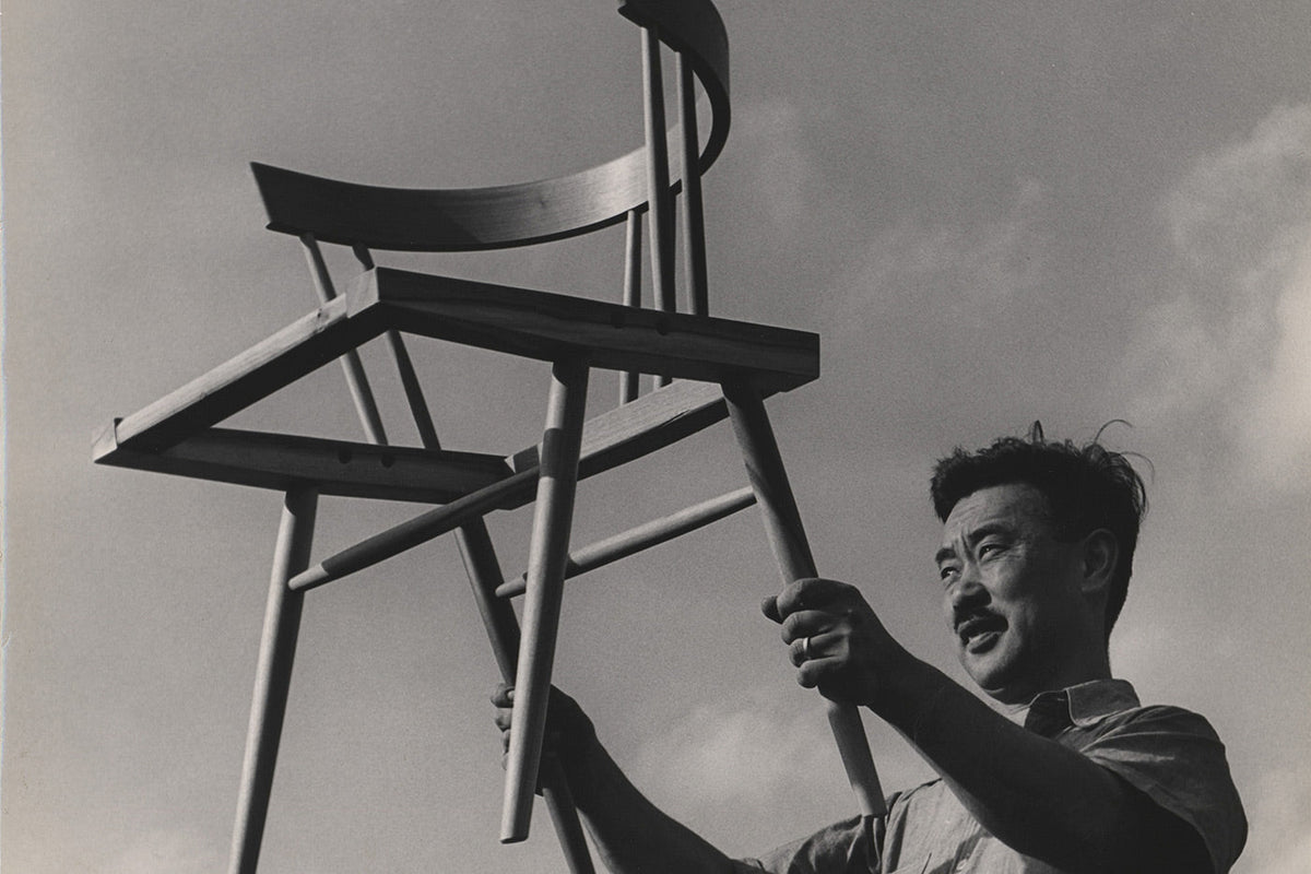 George Nakashima holding up a chair (image via Nakashima Woodworkers)